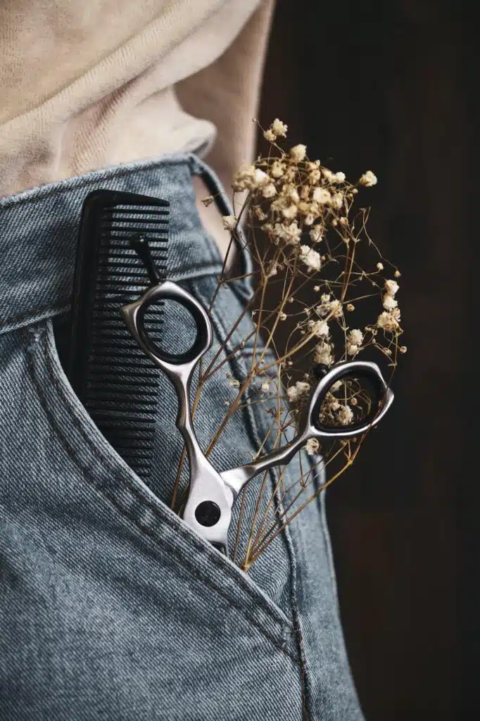 Hairdressing tools close-up in jeans with flowers