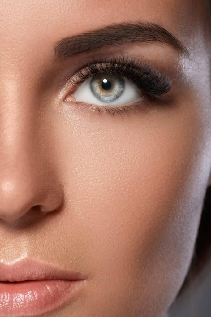 Female face with beautiful eyebrows and artificial eyelashes