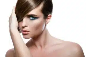 Model in stylish image with sleek hair covering one eye